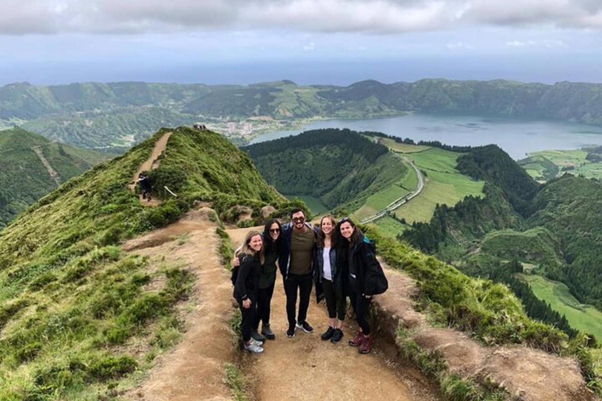 a group of people standing on top of a hill
