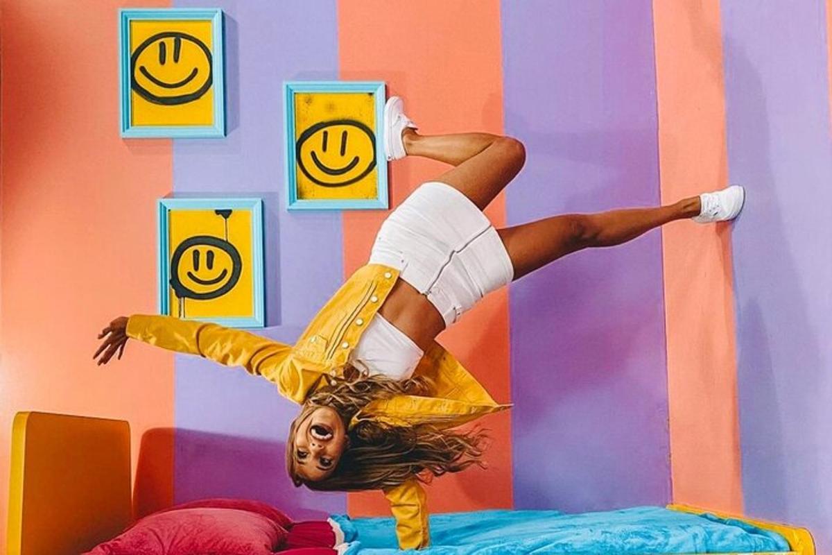 a woman doing a handstand on a bed