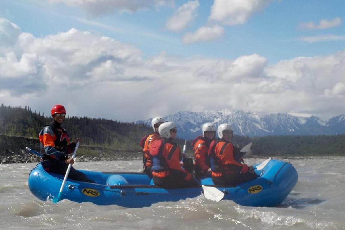 a group of people in a raft in the water