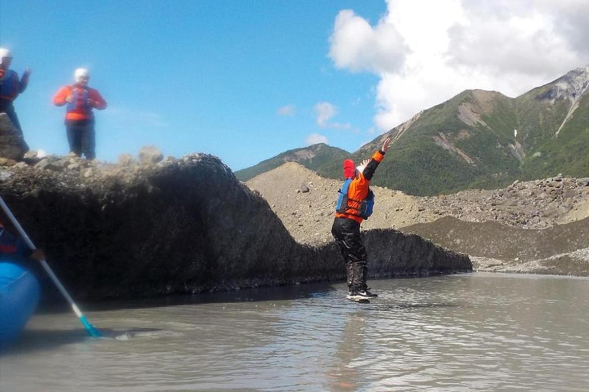 a man is standing in the water in a river