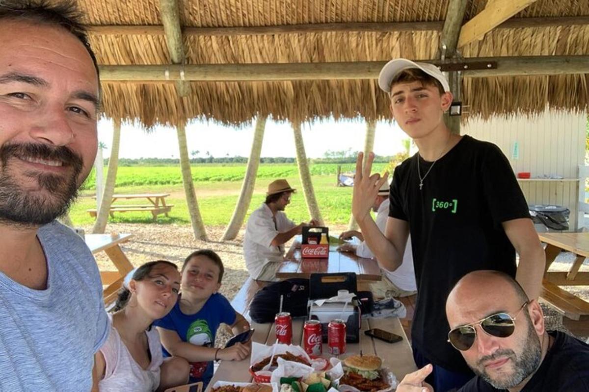 skupina lidí sedících u stolu s jídlem