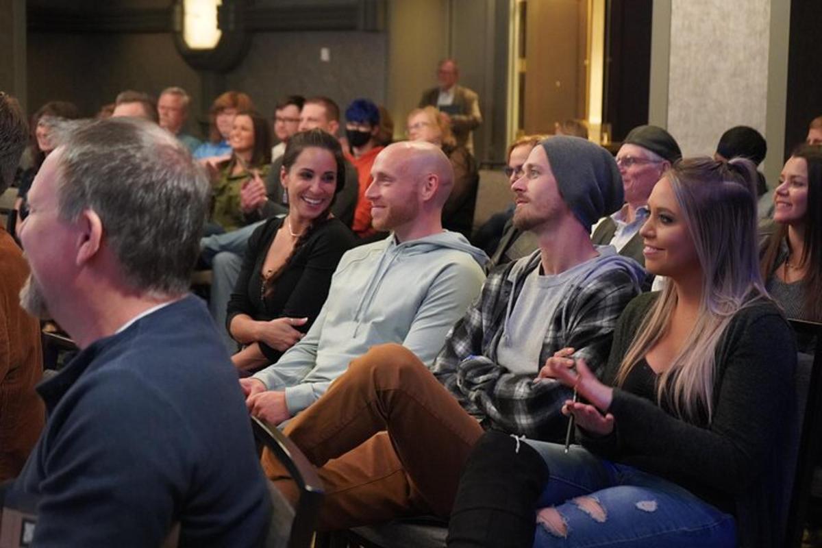 a group of people sitting in a crowd in a room