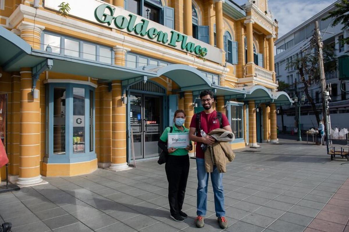 a man and a woman standing in front of a building