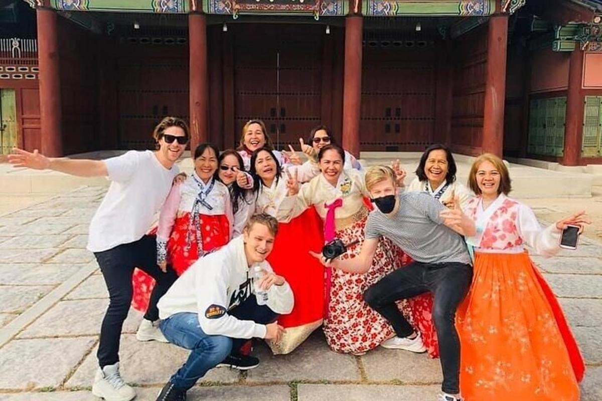 skupina lidí pózujících pro fotografii před budovou
