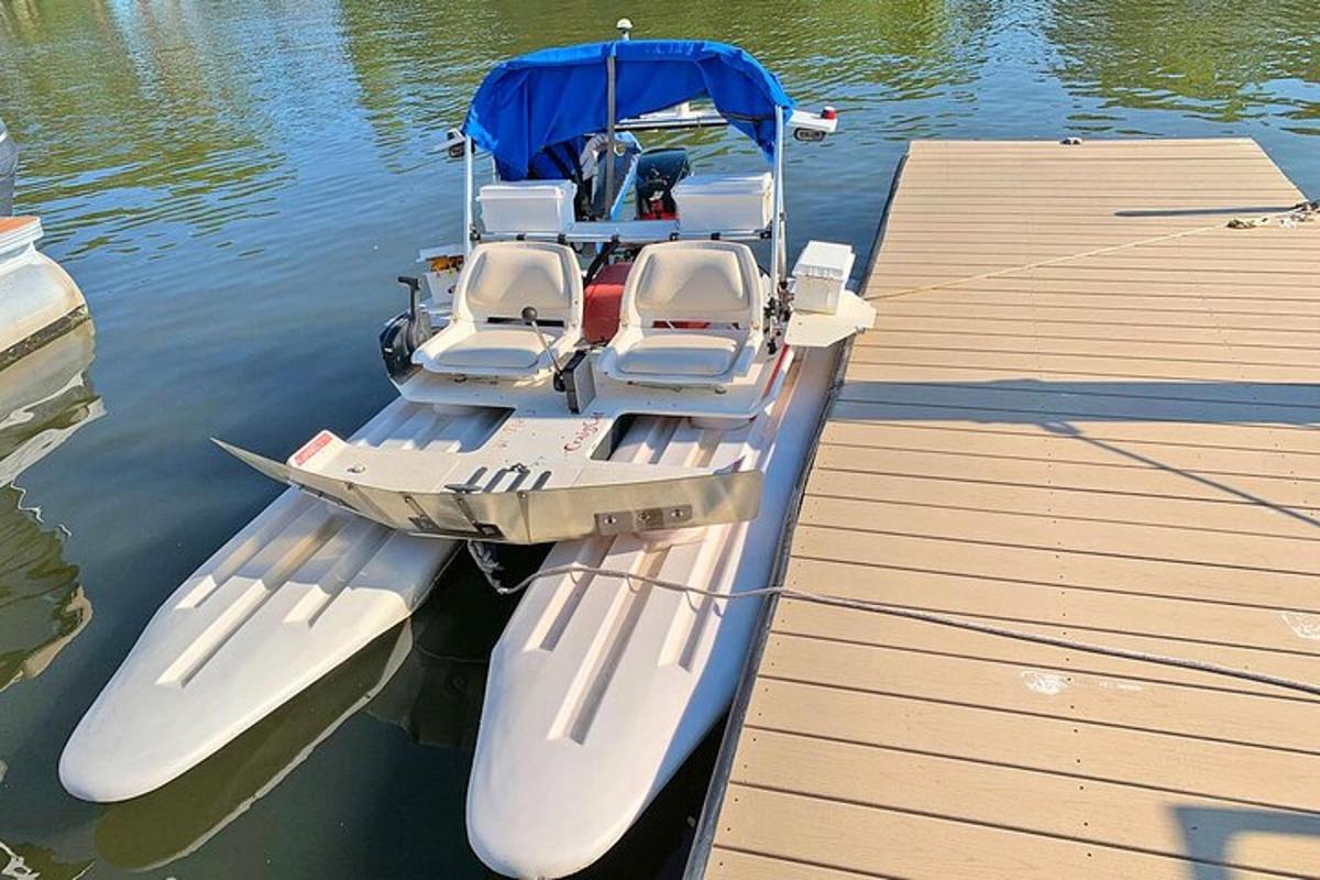 a boat docked next to a dock in the water