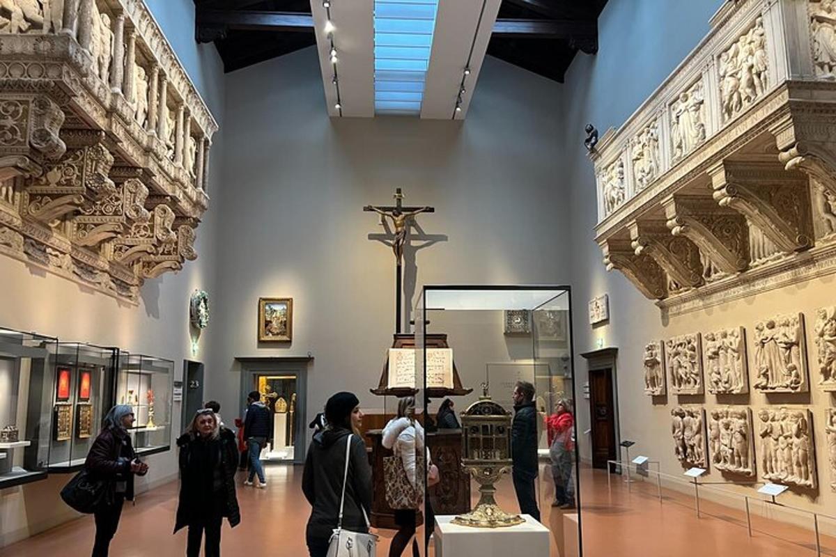 a group of people walking through a museum with a cross