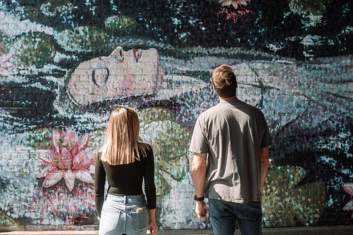 a man and a woman standing in front of a wall