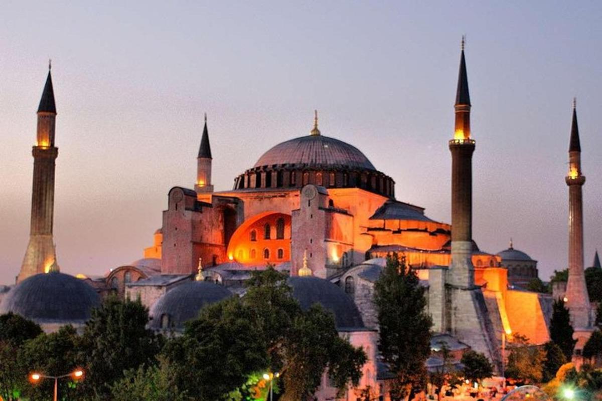 a large building with domes and mosques at night