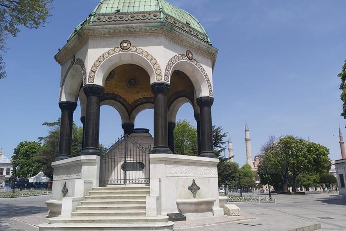 a gazebo with stairs and a green roof
