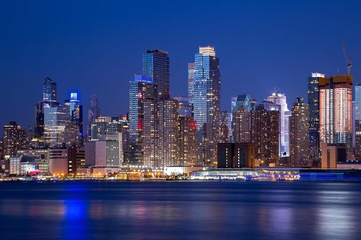 a night view of a large city with the water