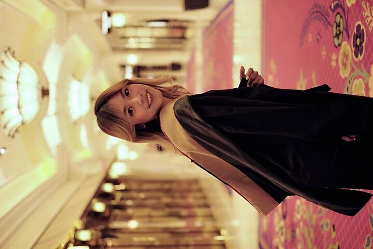 a woman in a black dress standing next to a aisle