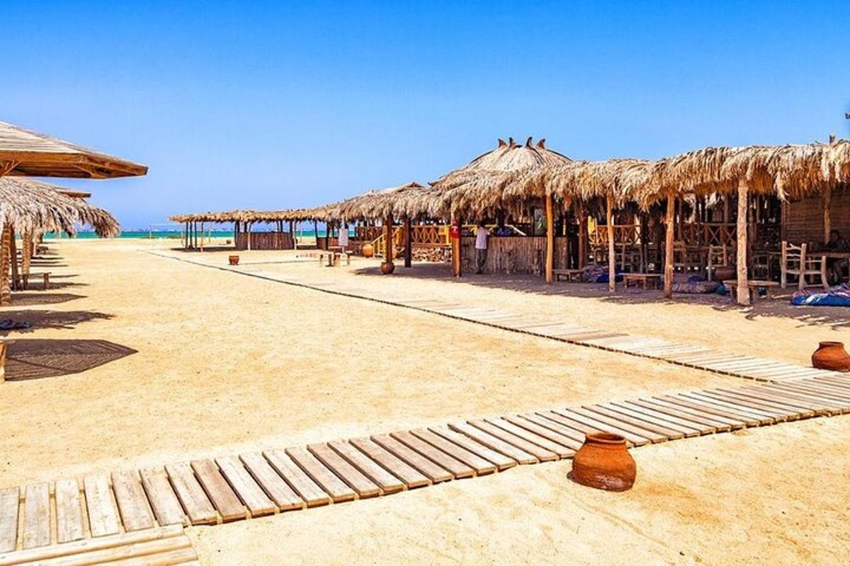 plaža z nekaj slamnatimi senčniki in ocean