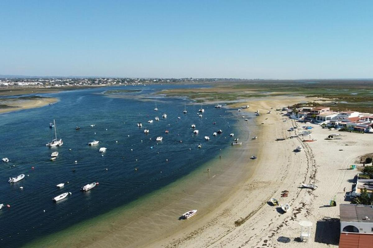 an aerial view of a beach with boats in the water