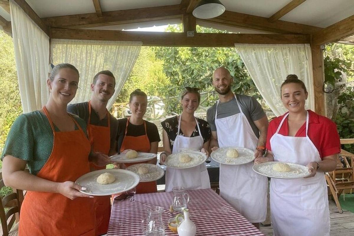 un gruppo di persone in grembiule che tengono piatti di cibo
