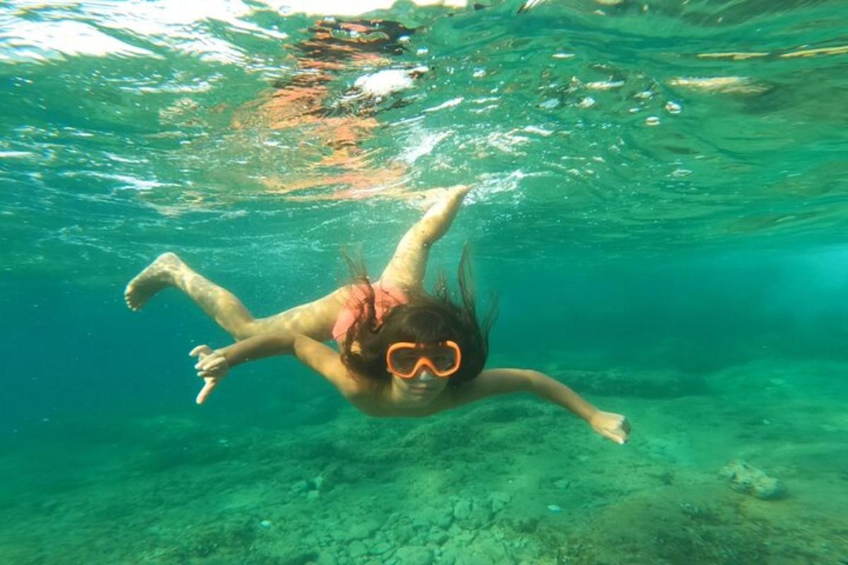 a woman swimming in the water with goggles on