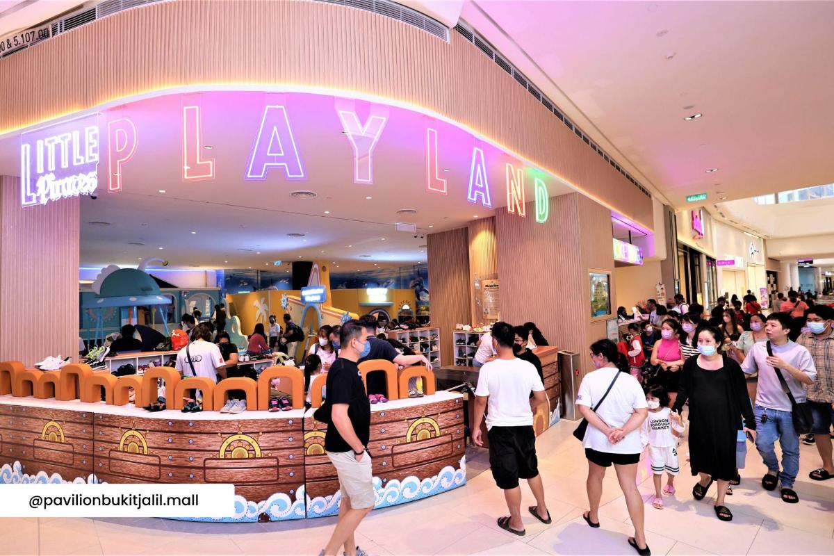 a crowd of people walking in a shopping mall