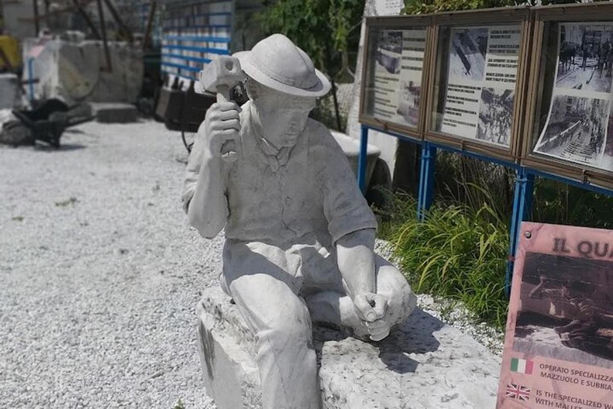 una estàtua d'un home assegut en un banc