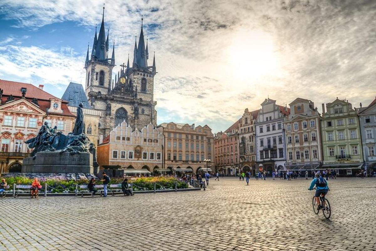 žena jedoucí na kole ve městě s kostelem