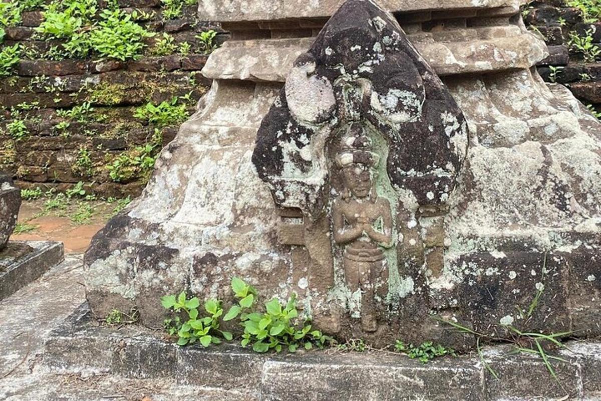 a statue of an angel on a stone wall