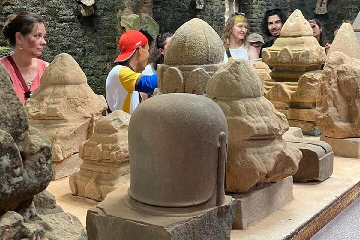 a group of people looking at a stone sculpture