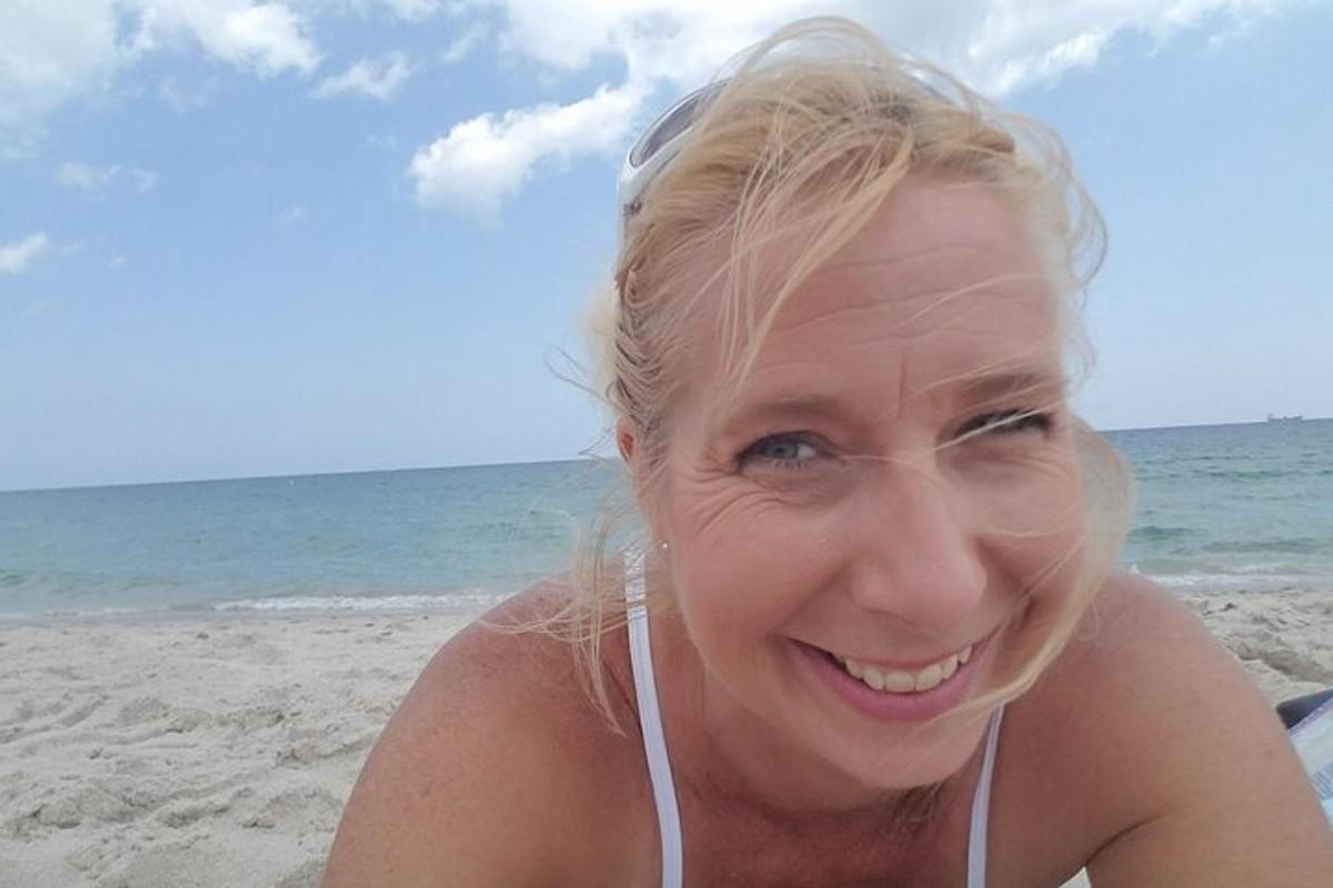 a woman sitting on the beach
