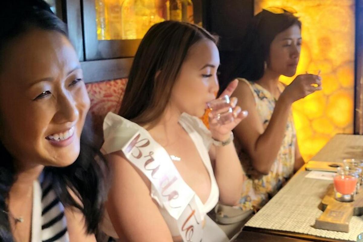 three young women sitting at a table in a restaurant