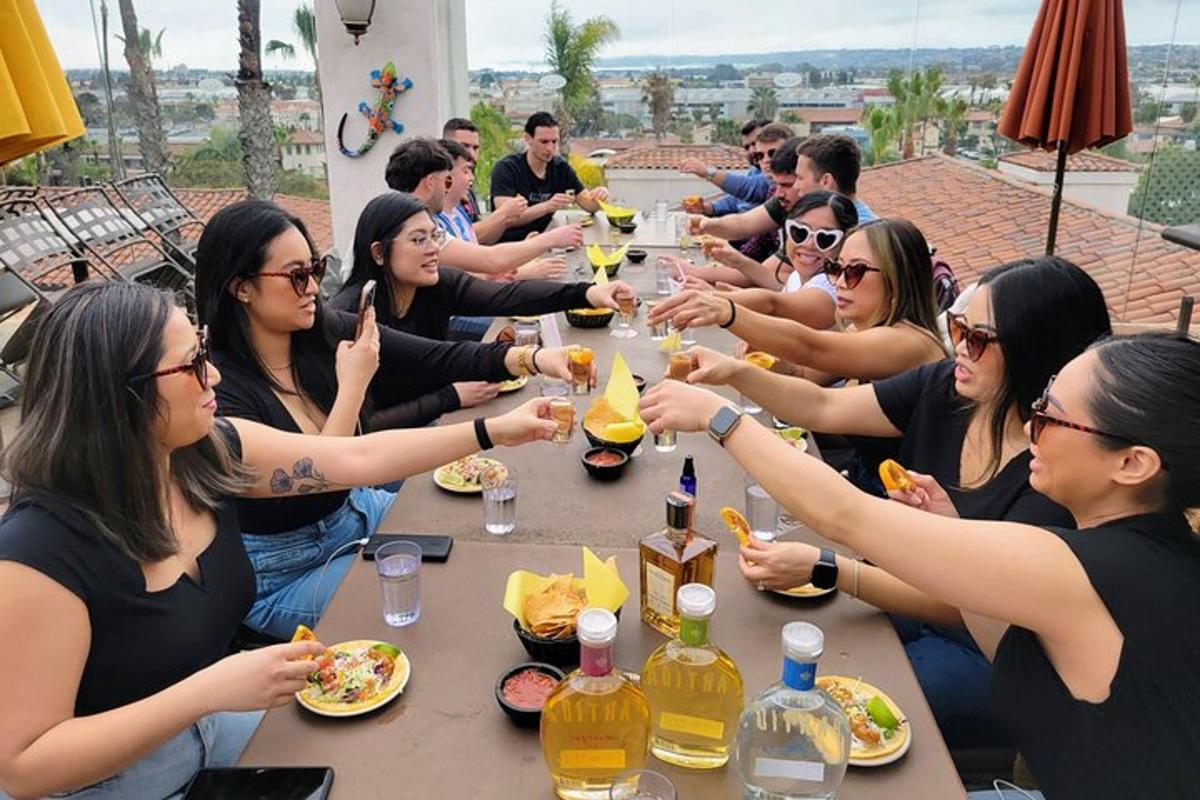a group of people sitting at a table eating food