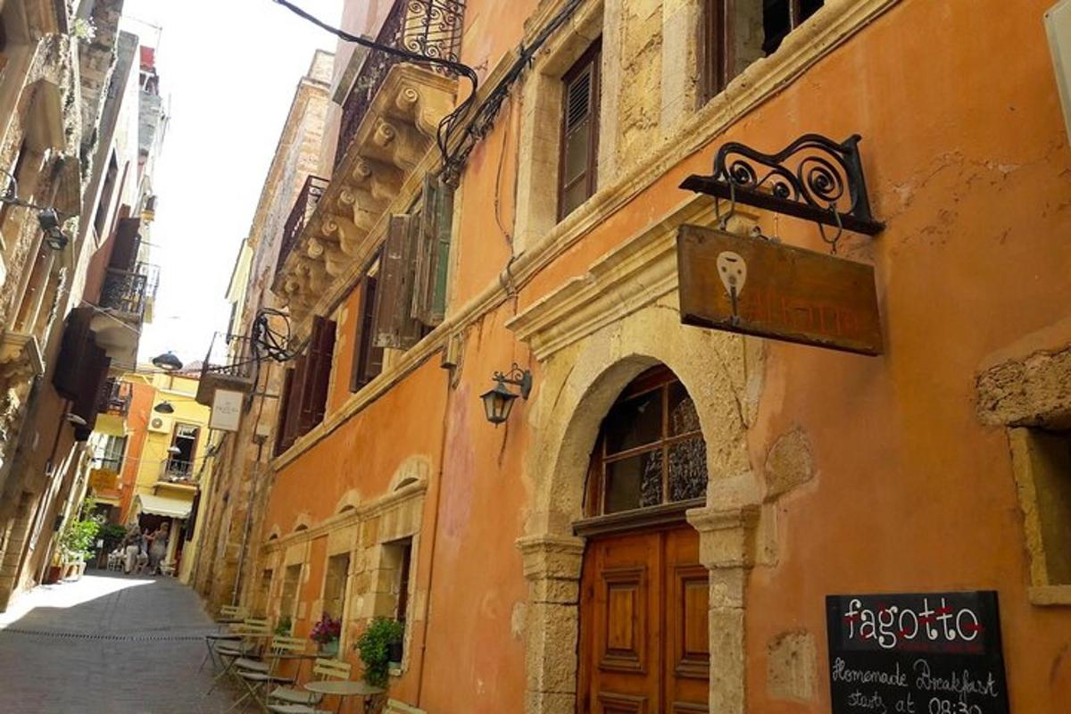 an alley with an orange building with a door