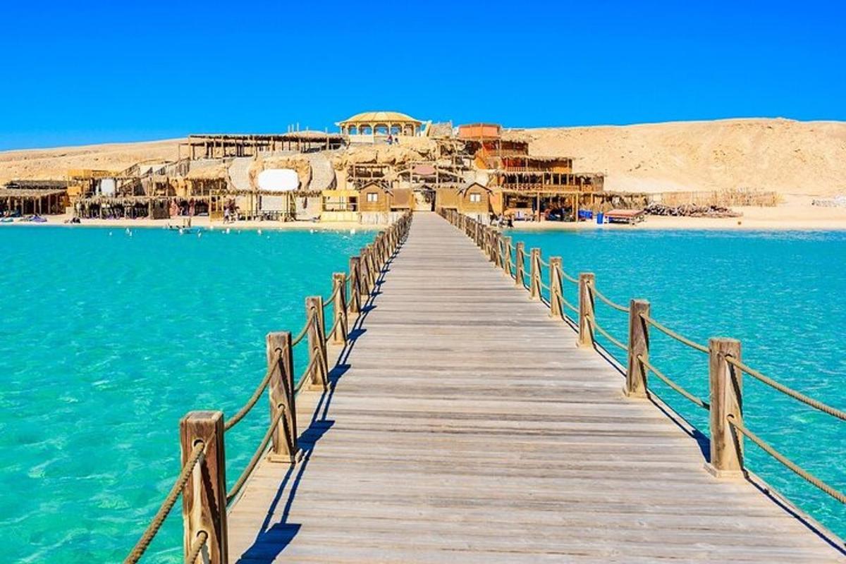 a wooden bridge over the water with a resort