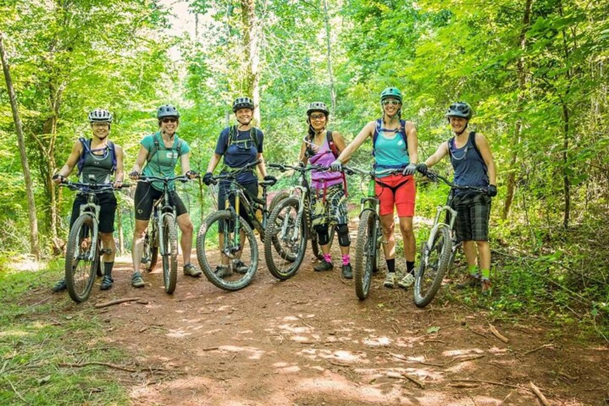 a group of people riding bikes on a trail