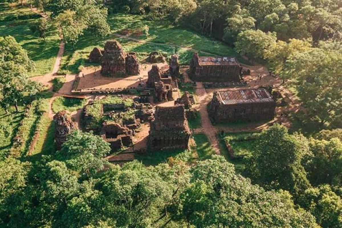 an aerial view of an old building in a forest