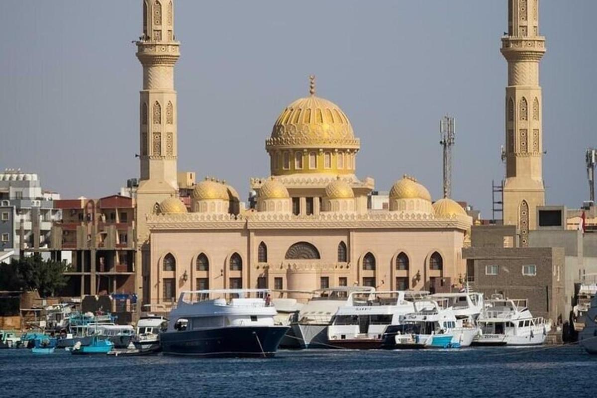 um grande edifício com cúpulas e barcos na frente