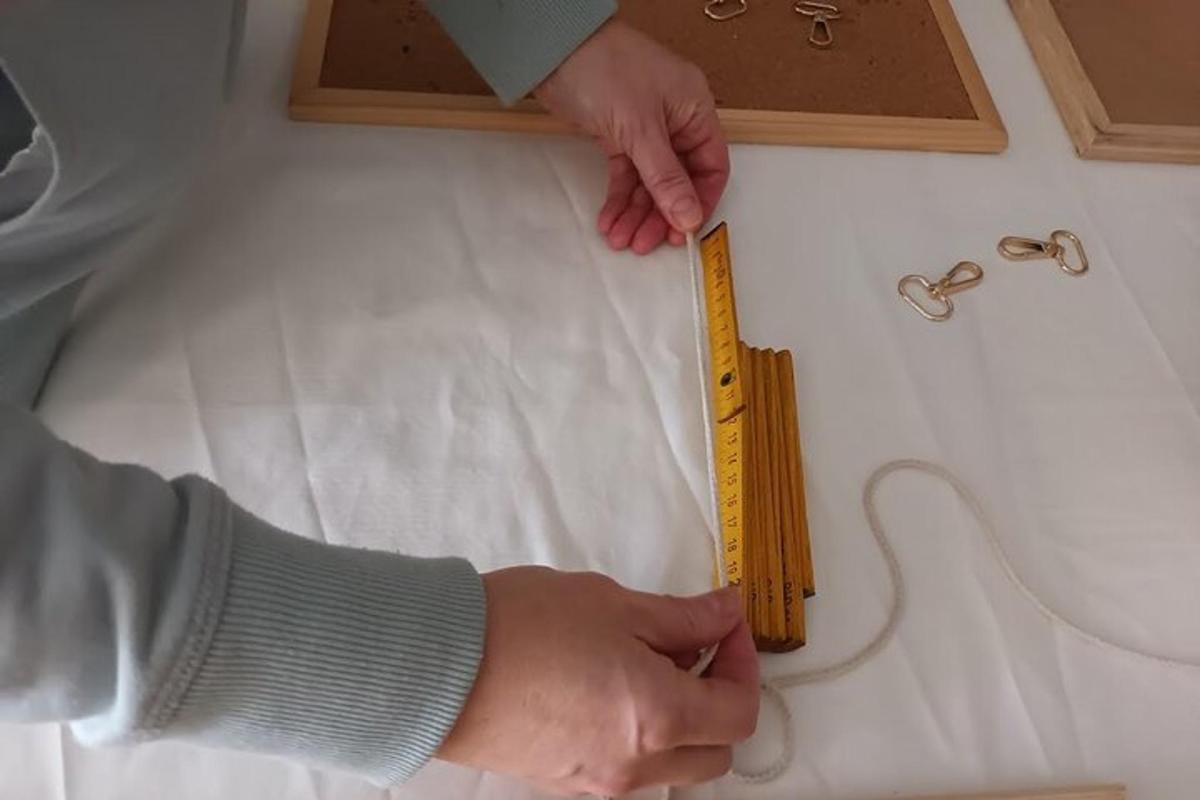 osoba držící žluté pravítko na pultu