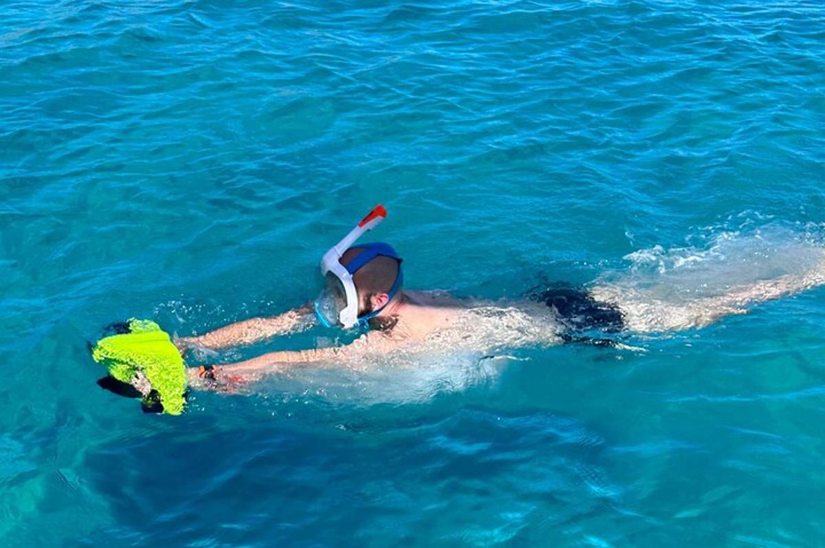 un uomo che nuota in acqua con un subacqueo