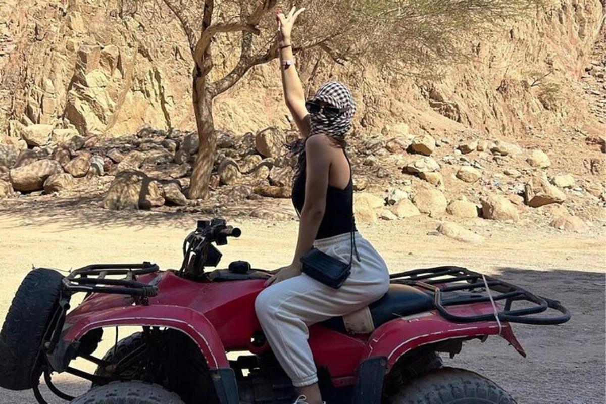 a woman is sitting on a quad bike