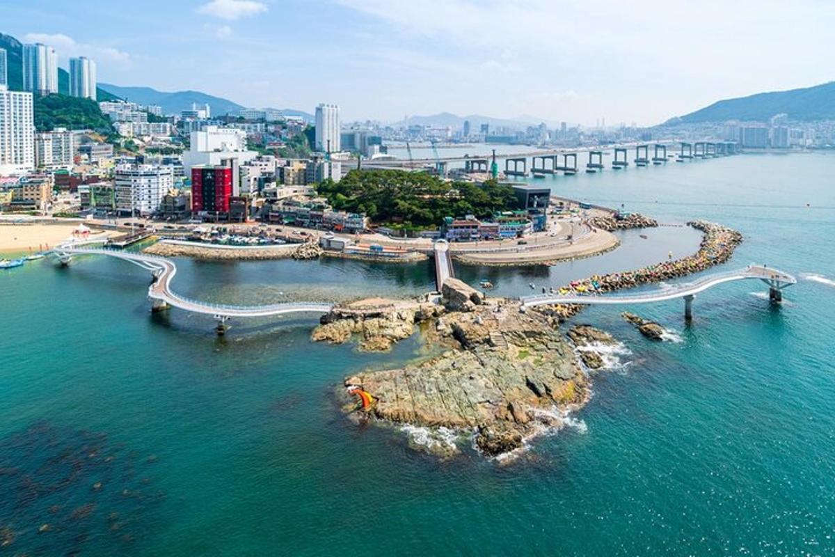 an island in the ocean with a city in the background