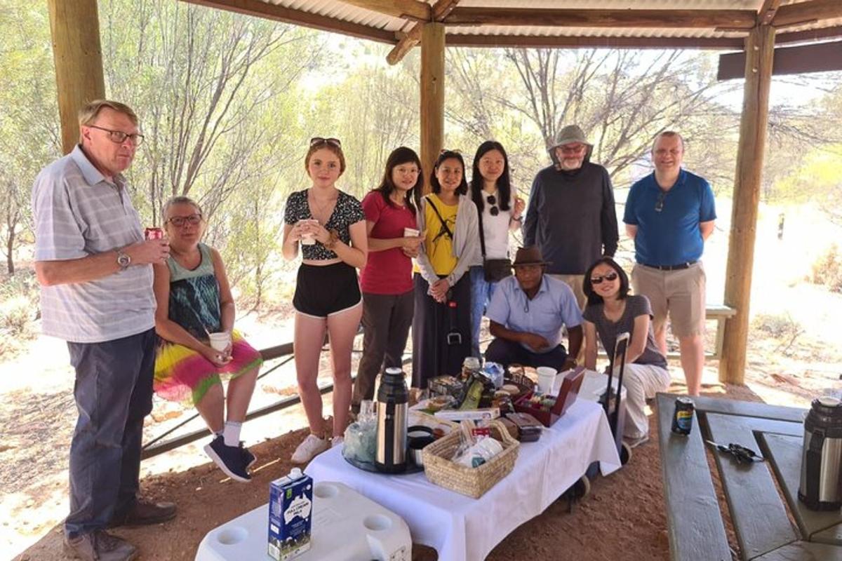 a group of people posing for a picture in front of a table