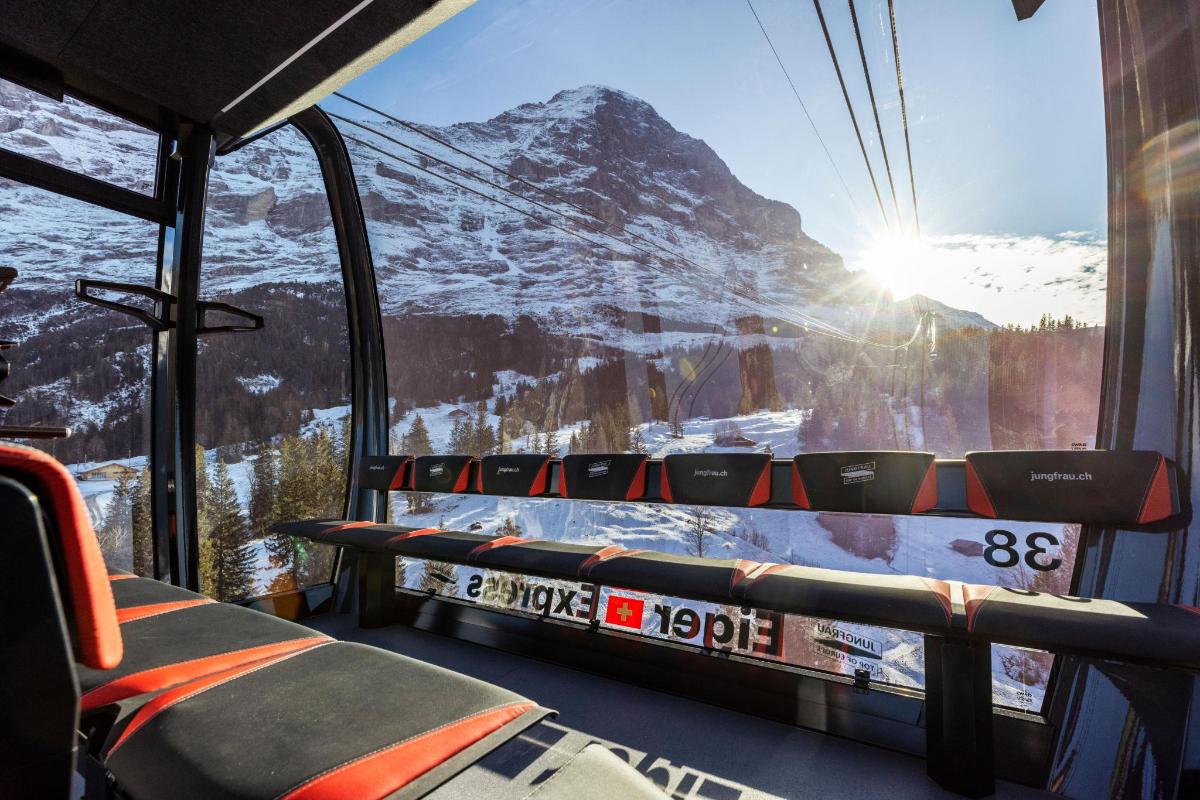 a tram with a view of a snow covered mountain