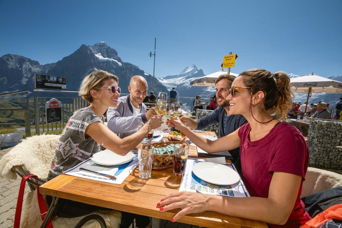 a group of people sitting at a table drinking wine