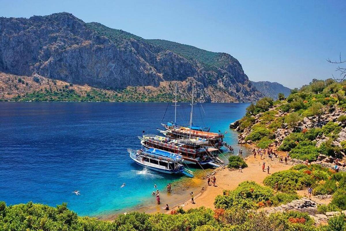 two boats on a beach with people on it