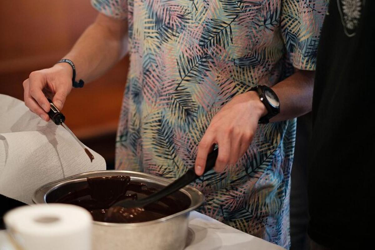 a person preparing food in a pot on a table