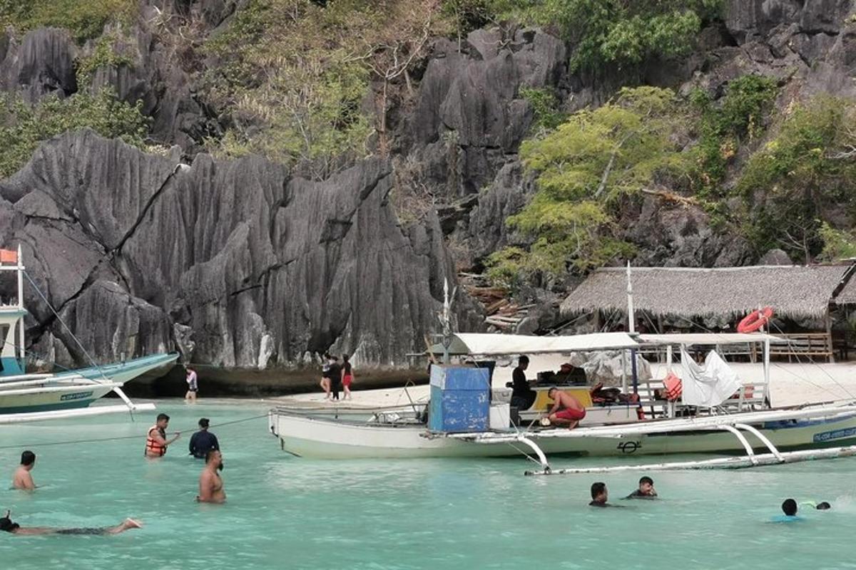 a group of people in the water next to a boat