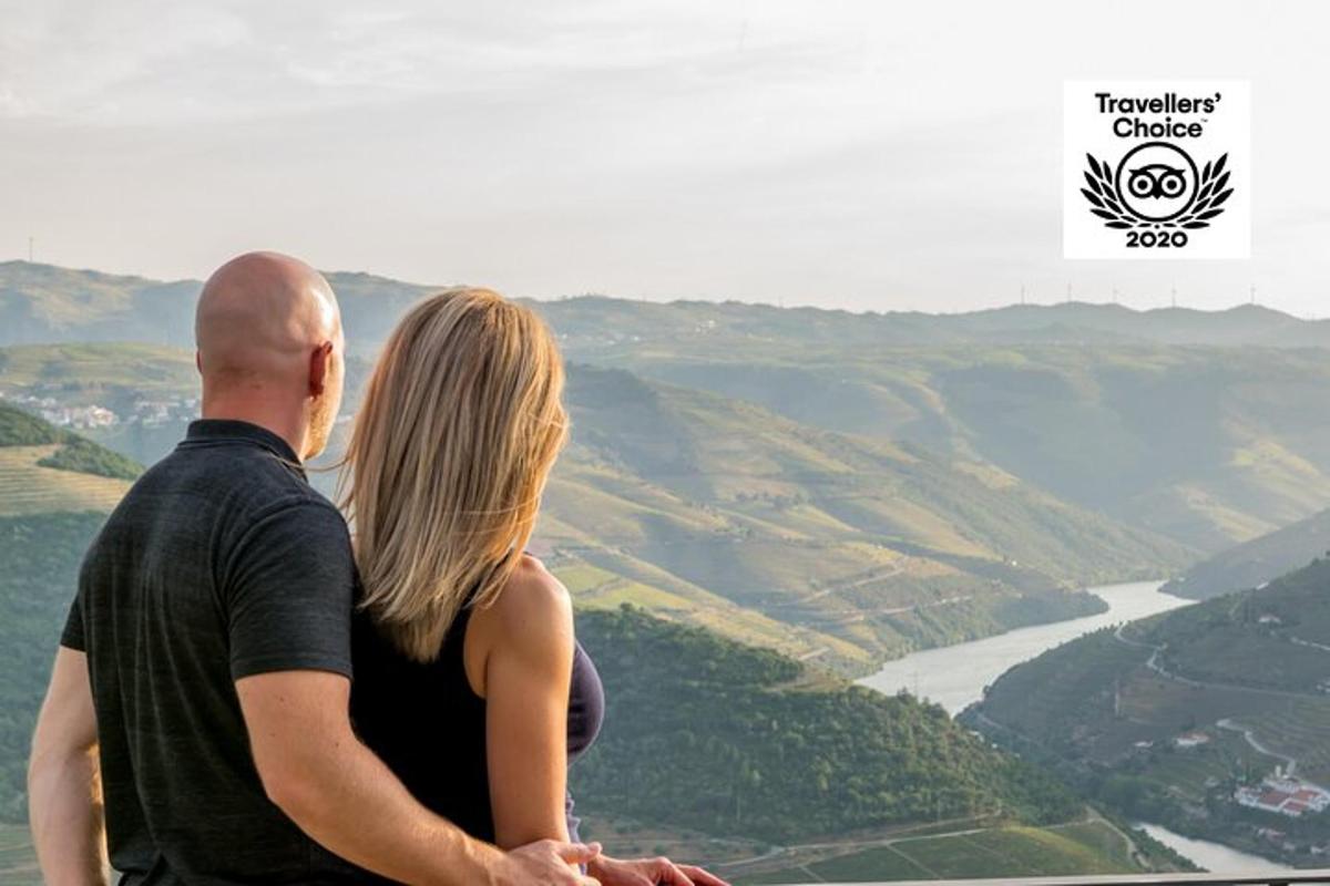 a man and a woman standing on top of a mountain