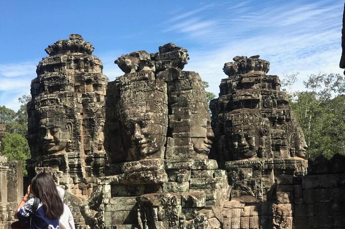 seorang wanita berdiri di hadapan kuil batu
