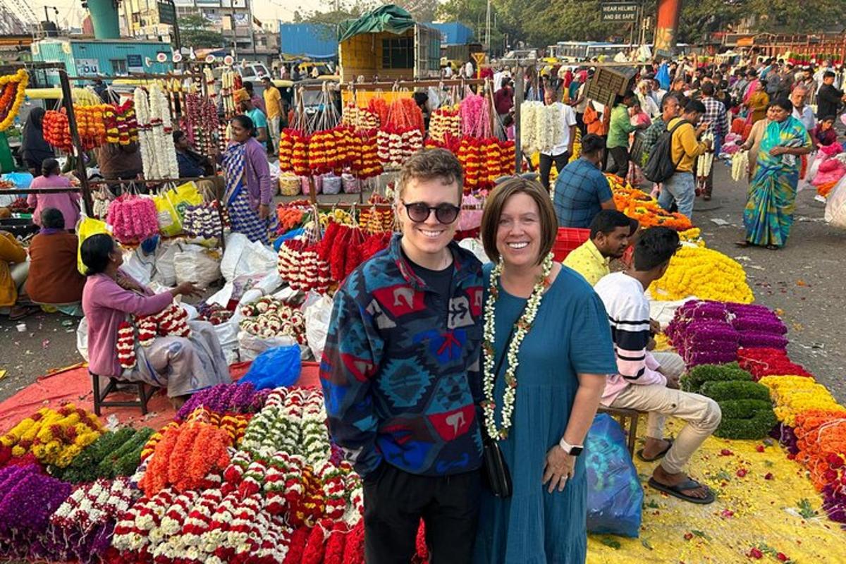 a man and woman posing for a picture in a market