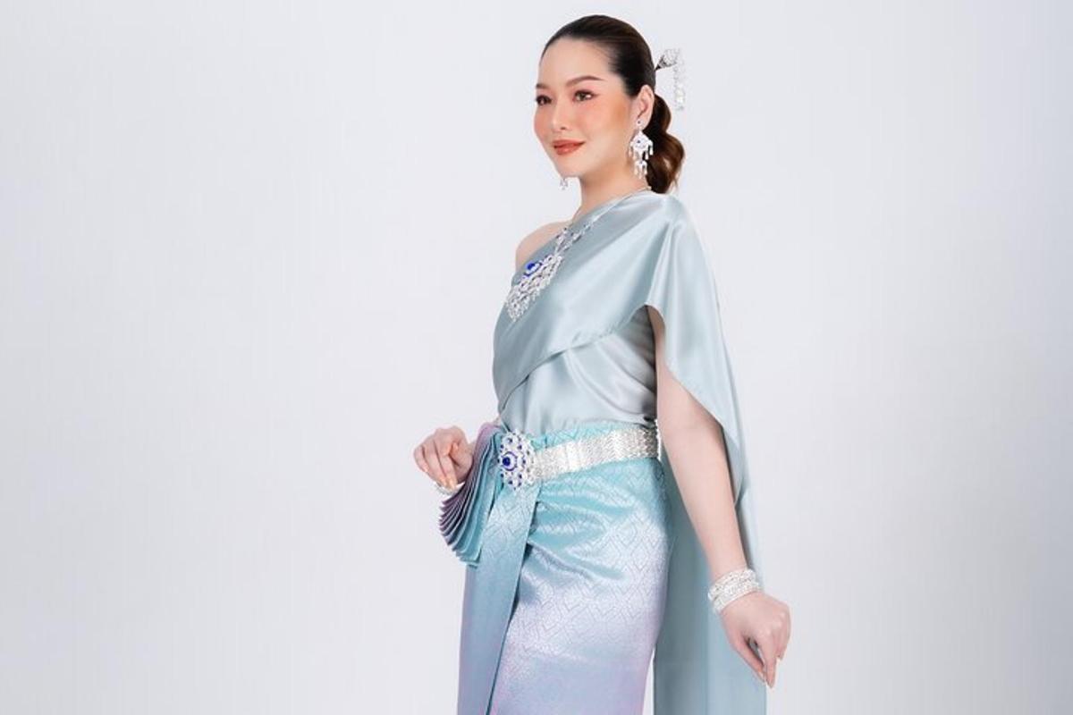 a woman wearing a blue dress with a blue clutch