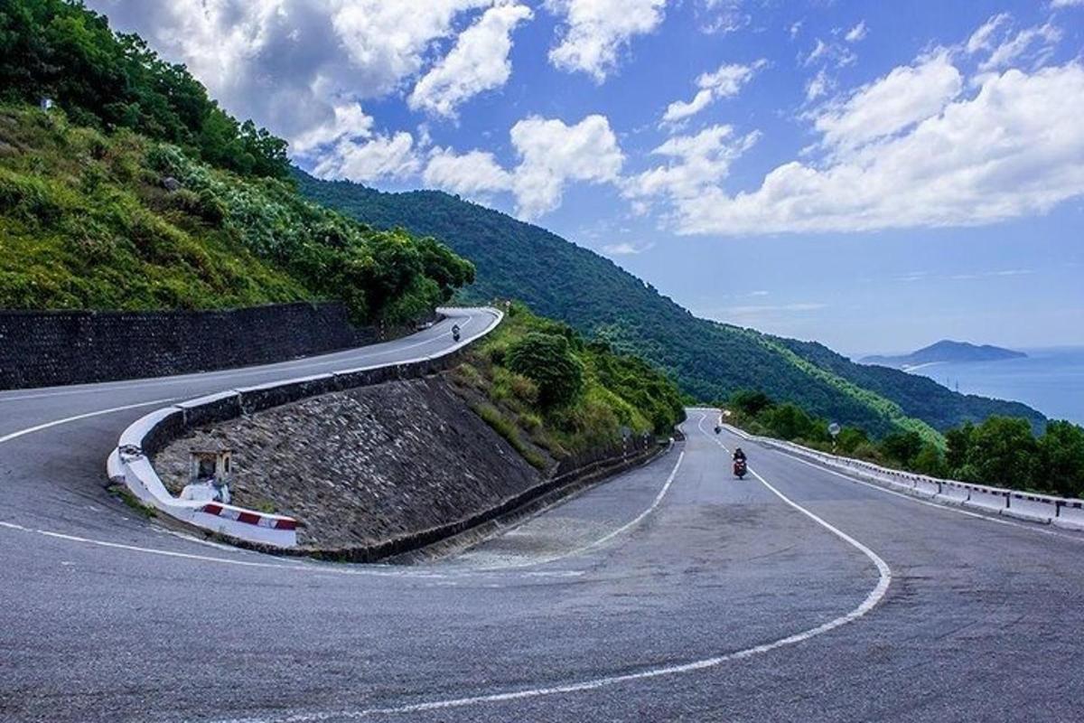 klikatá silnice s osobou jedoucí na motorce na kopci