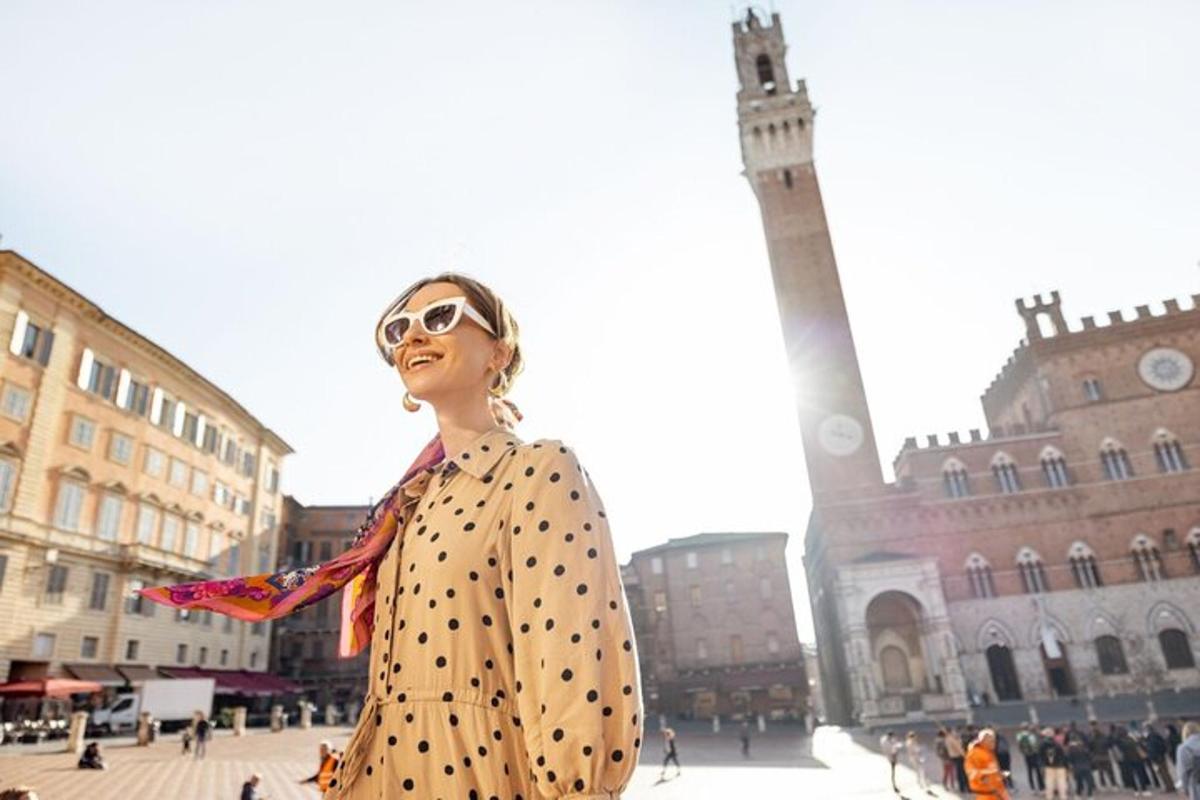 uma mulher com um vestido de bolinhas parada em frente a uma torre