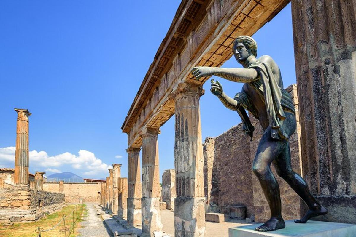 a statue of a man leaning against a building