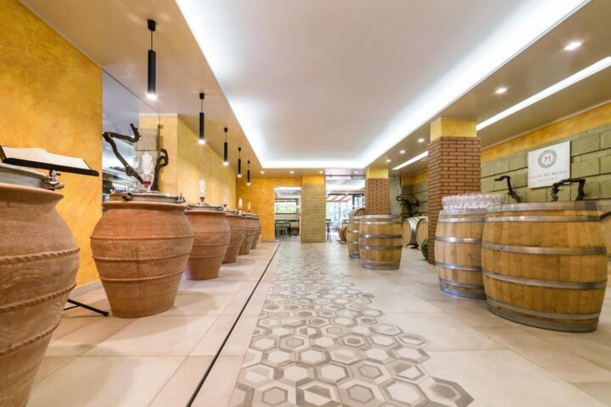 a row of wine barrels in a wine cellar